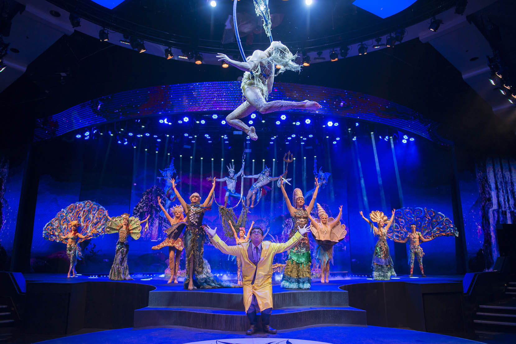 WOW Show performers and aerialist under saturated blue lighting
